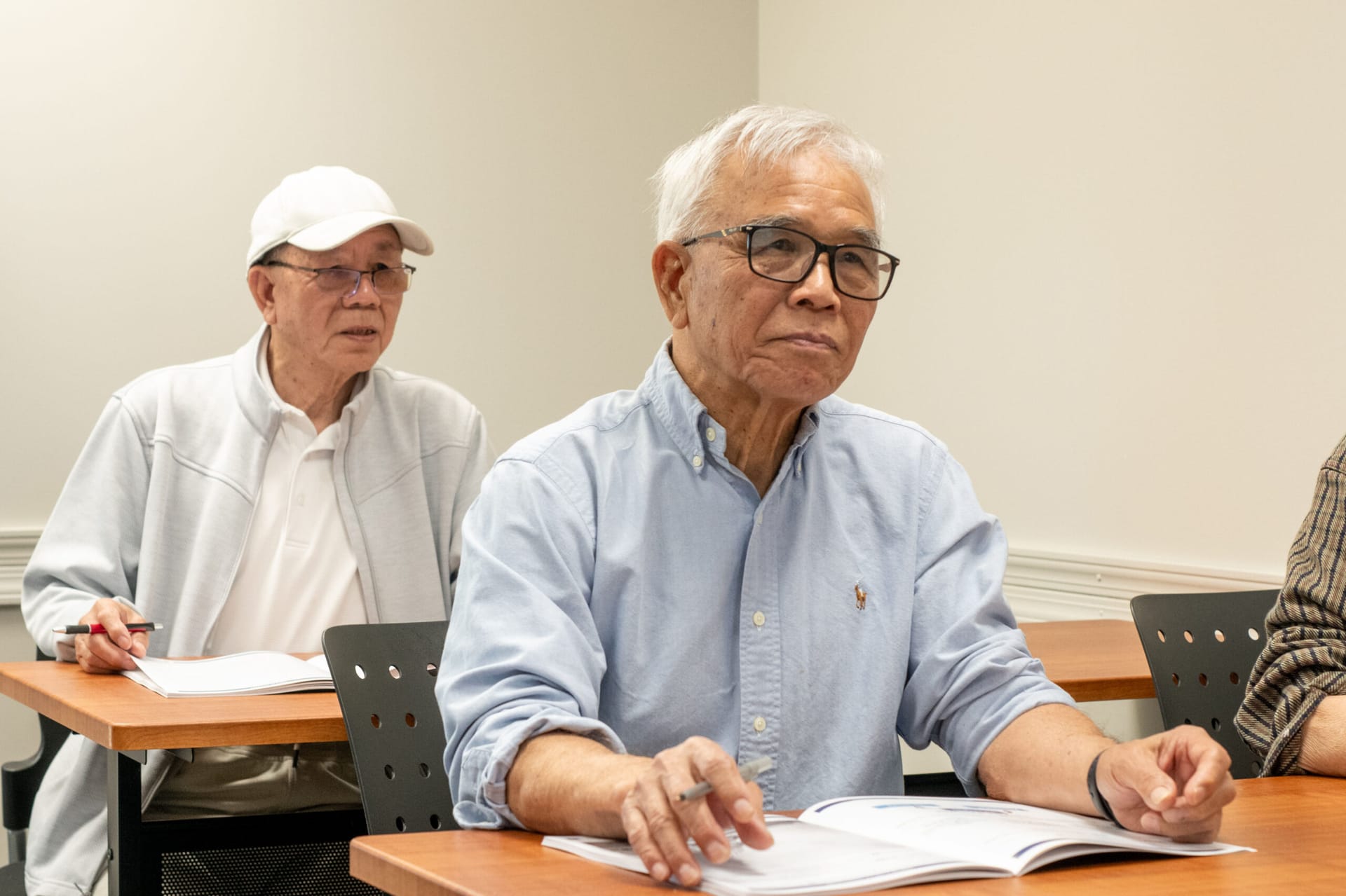 Middle-age men in a classroom.